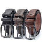 Three leather belts in black, brown, and gray with silver buckles on a white background.