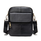 Black leather crossbody bag with gold zippers on a white background