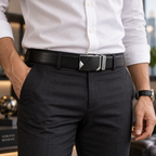 A close-up of a man wearing a black leather belt with a silver geometric automatic buckle, paired with a white dress shirt and dark gray trousers.