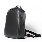 Black leather backpack on a white background
