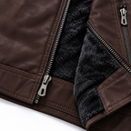 Coffee - Close-up of a dark brown faux leather jacket showing the silver metal zipper, stitching, and a black faux-fur lining.