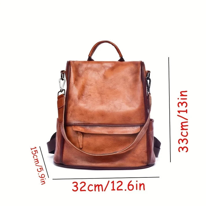 A brown faux-leather backpack shown on a white background with red dimension lines and text indicating measurements: 33cm/13in height, 32cm/12.6in width, and 15cm/5.