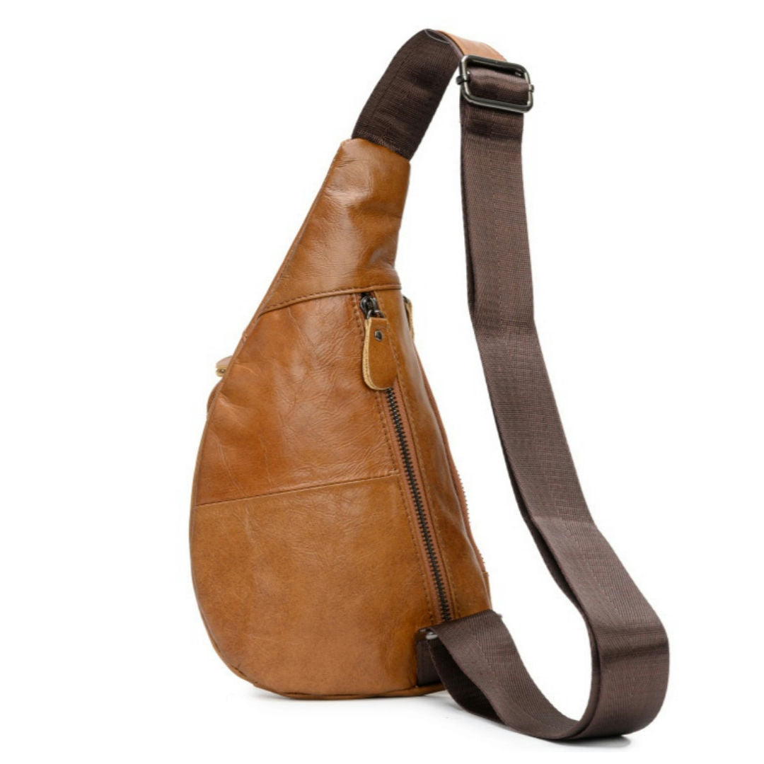 Brown leather sling bag with a strap on a white background