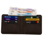 Brown leather wallet with credit cards and British banknotes on a white background