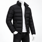 Black - A black puffer jacket with a stand-up collar and front zipper, shown on a white mannequin torso wearing a white shirt and dark jeans against a plain white background.