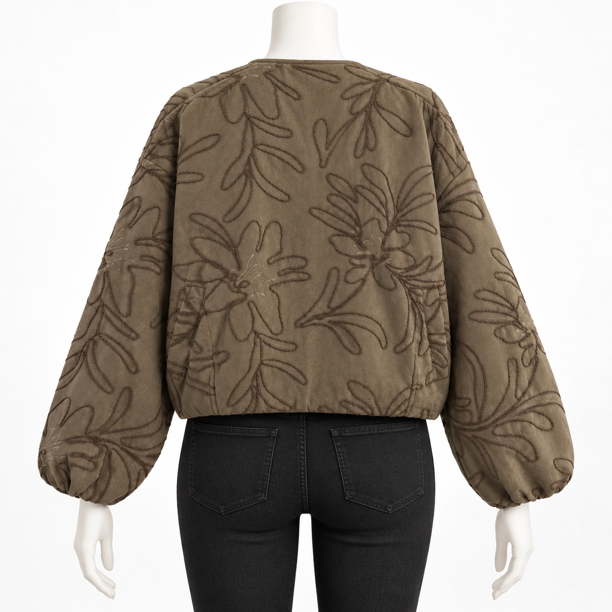 Green - A cropped, long-sleeve quilted jacket with an allover tonal floral and leaf pattern, shown from the back on a mannequin wearing black jeans against a white background.