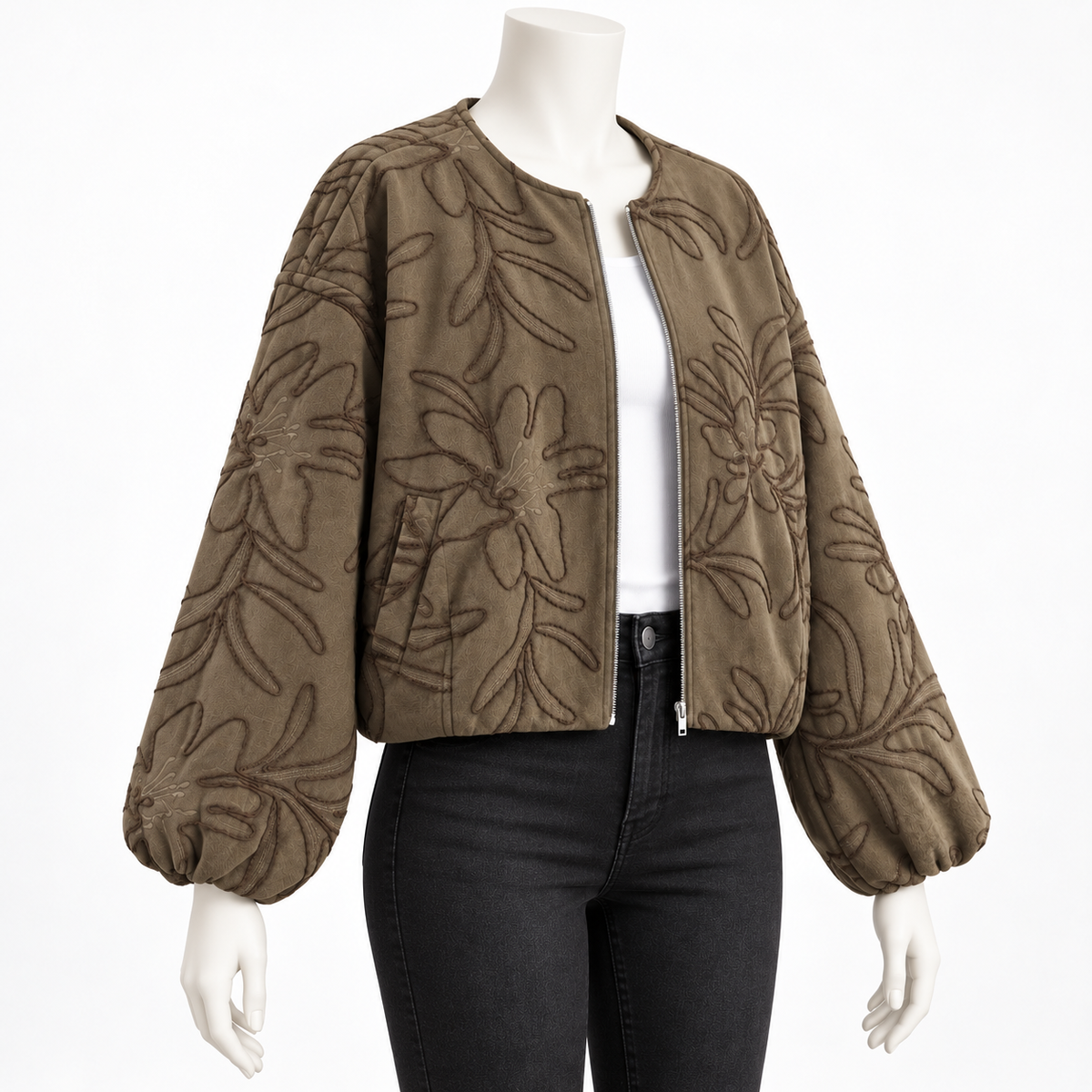 Green - A cropped, zip-front jacket with voluminous balloon sleeves, shown on a mannequin. The jacket is a muted taupe-brown color with a raised, tonal floral pattern.