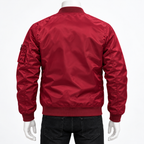 Red - A red nylon bomber jacket shown from the back on a mannequin wearing black jeans, against a plain white background.