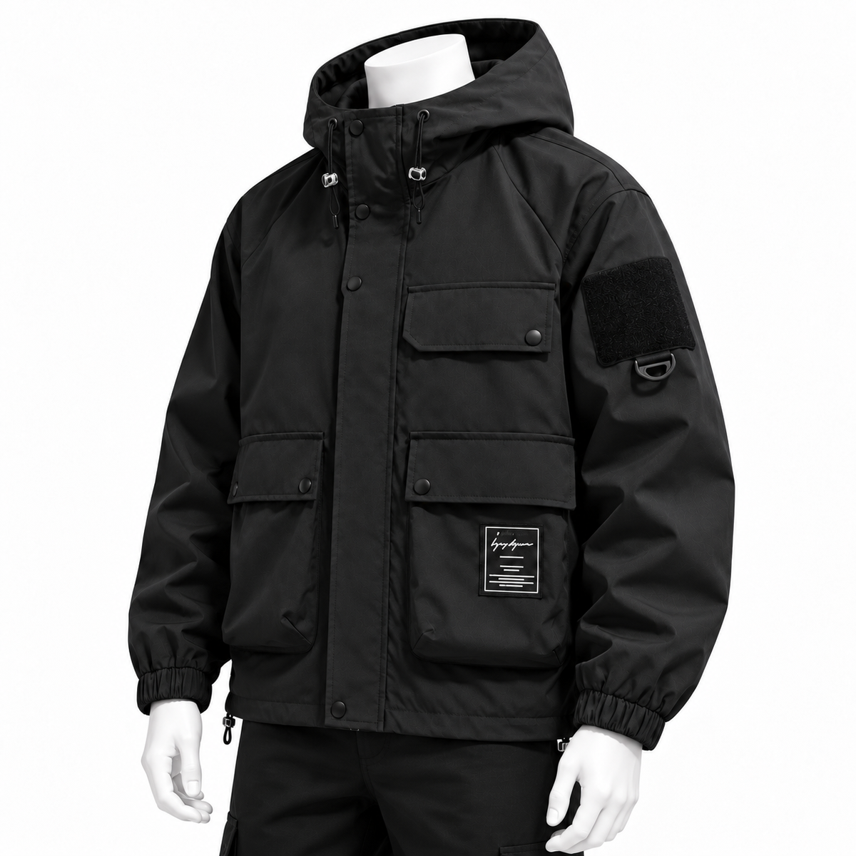Black - A black hooded utility jacket displayed on a white mannequin torso and arms against a plain white background. The jacket features multiple front flap pockets, elasticized cuffs, a hood, and a black patch on the upper sleeve.