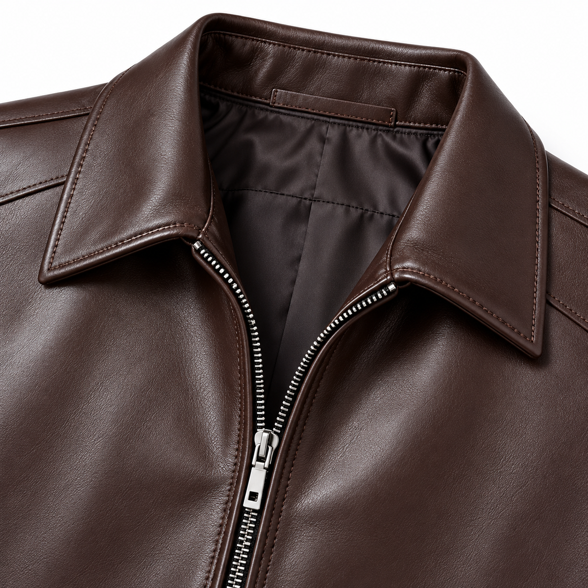 Close-up of a dark brown leather jacket with a pointed collar, silver zipper, and smooth interior lining on a white background.