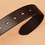 Black leather belt on a beige background