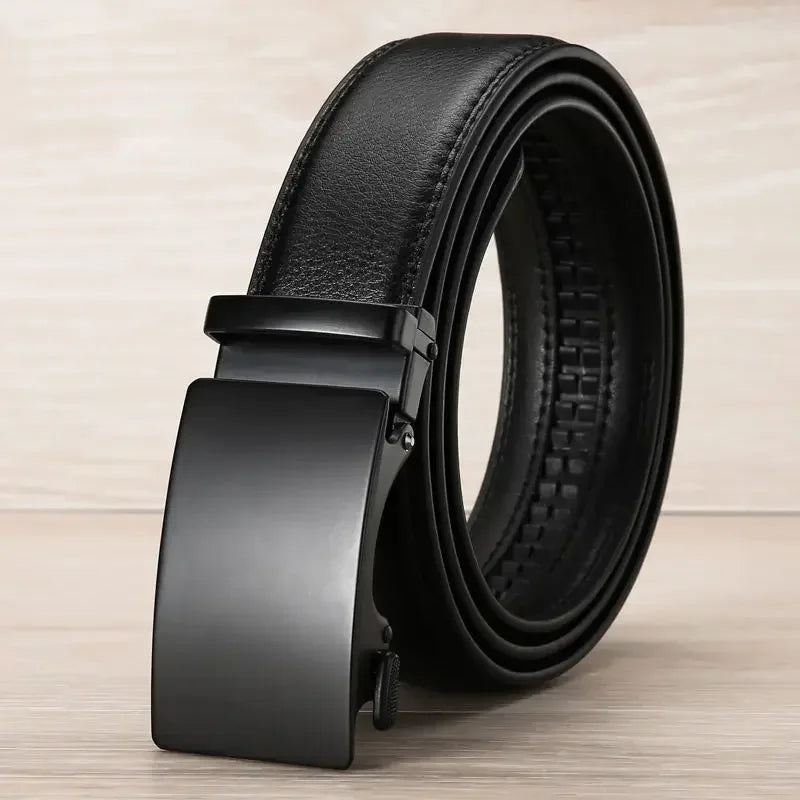 Black leather belt with a black buckle on a light wooden surface