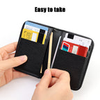 Hands demonstrating access to the internal slots of an open black vegan leather card holder.