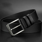 Black leather belt with a silver buckle on a dark background