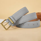 Gray belt with a gold buckle on a beige background