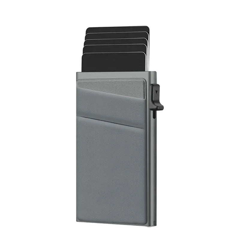 A slim metallic gray cardholder wallet with several black cards partially pulled out from the top, shown on a plain white background.