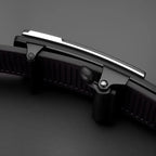 Close-up of a black and silver knife handle on a dark background