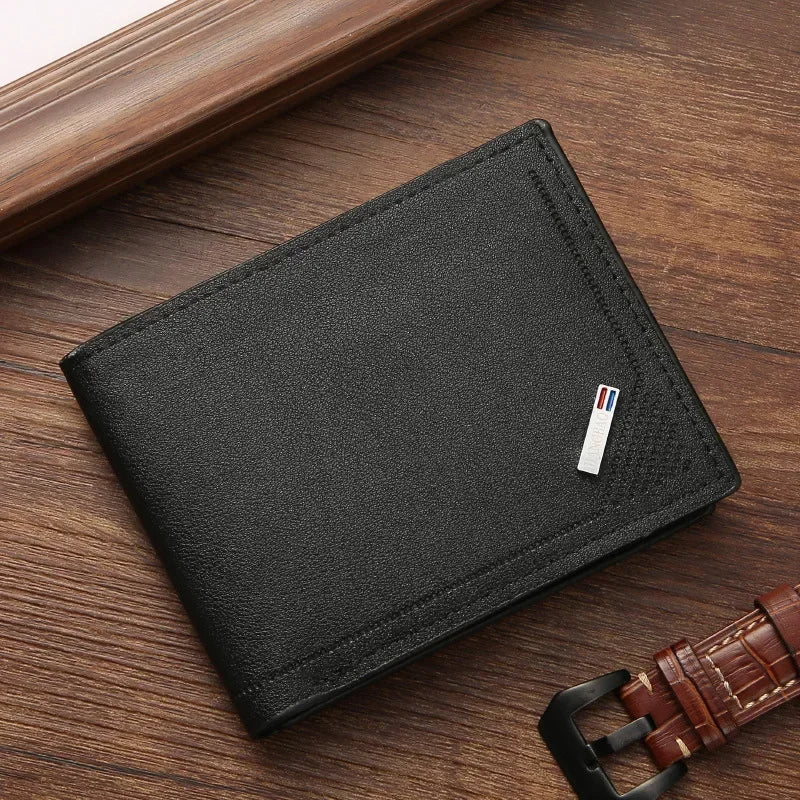 Black wallet with a brand logo on a wooden surface next to a brown leather belt.