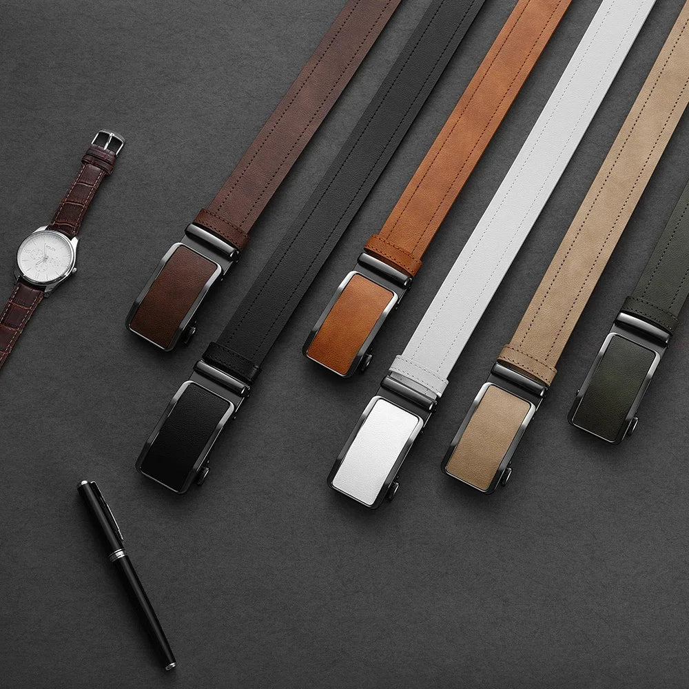 Set of leather belts in various colors on a dark surface with a watch and pen.