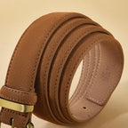 Brown leather belt with a gold buckle on a beige background