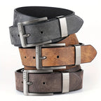 Stack of three leather belts with metal buckles on a white background