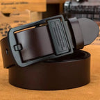 Brown leather belt with black buckle on a wooden surface