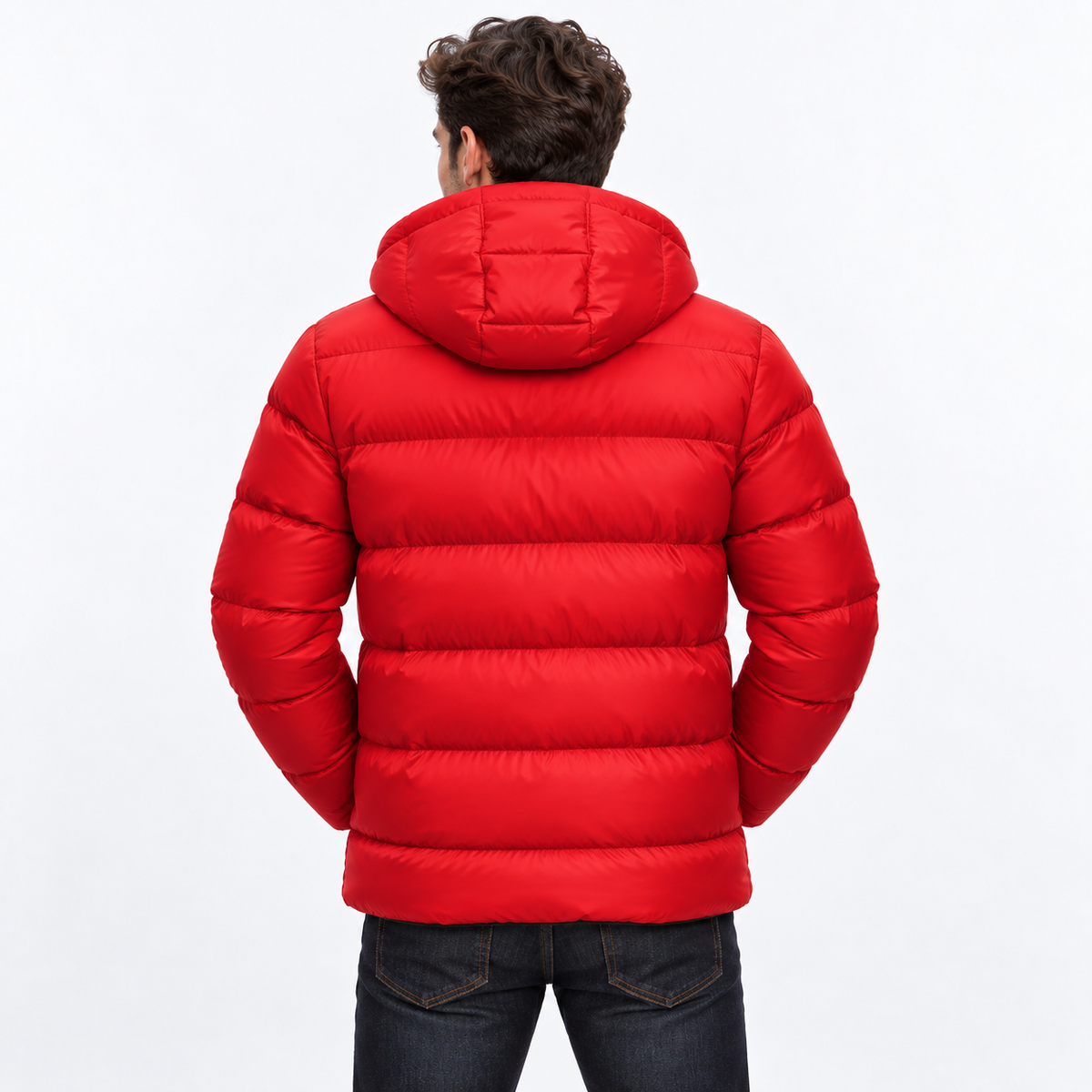 Red - A man viewed from behind wearing a bright red hooded puffer jacket and dark blue jeans against a plain white studio background.