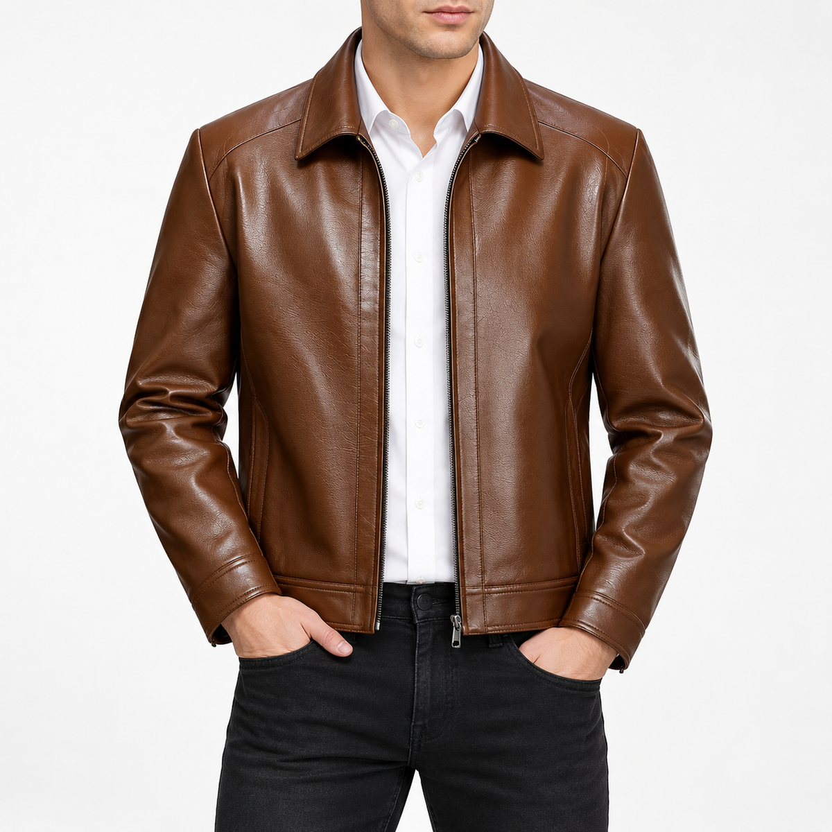 Brown - A man wearing a brown leather jacket over a white collared shirt and black jeans, standing against a plain light gray studio background.