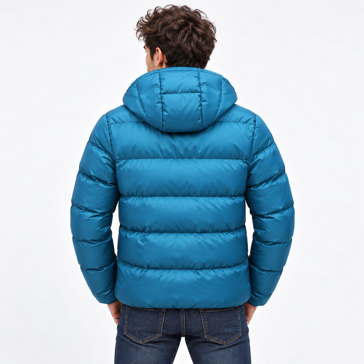 Blue - A man viewed from behind wearing a bright teal-blue hooded puffer jacket and dark blue jeans against a plain white studio background.