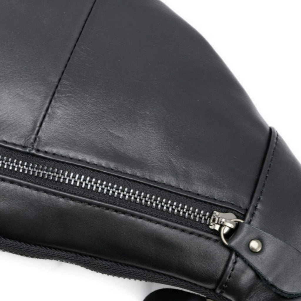 Close-up of a black faux leather bag with a silver zipper and metal hardware, set against a plain white background.