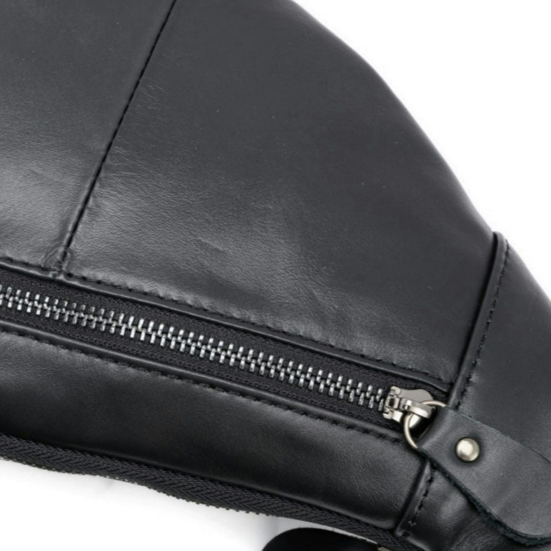 Close-up of a black faux leather bag with a silver zipper and metal hardware, set against a plain white background.